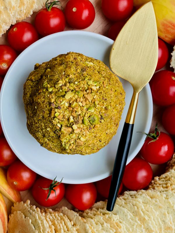 Bacon Gouda Pistachio Cheese Ball on a small white plate