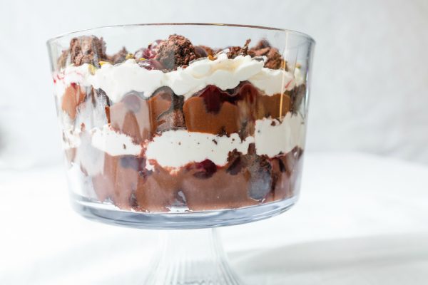 layers of brownies, whipped cream, pudding, cherries