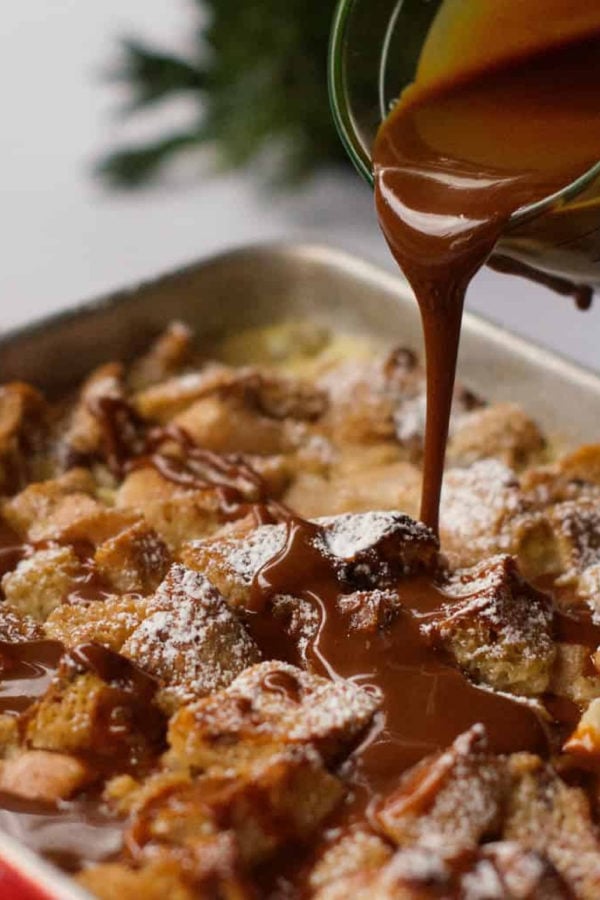 pouring caramel sauce over bread pudding with pears