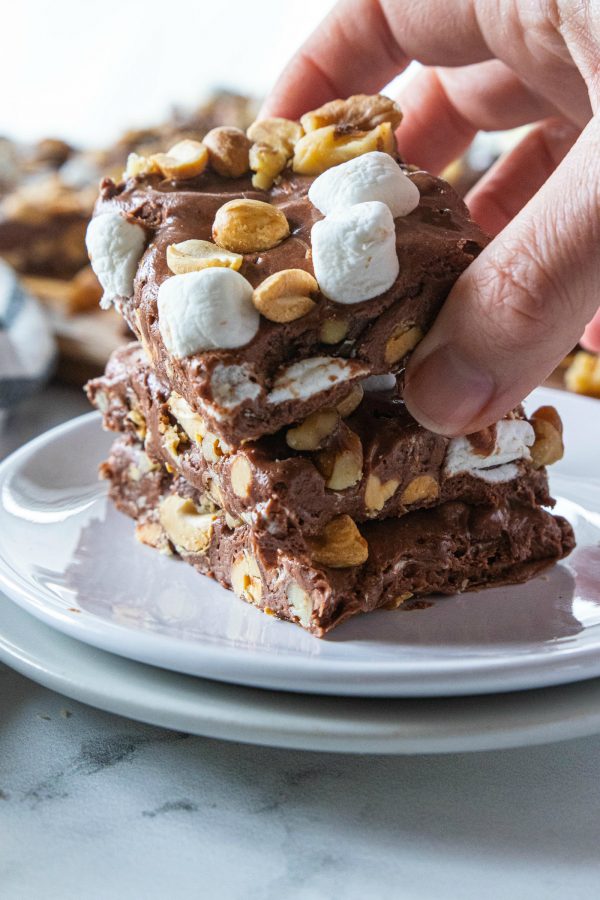 stacking rocky road fudge on a plate