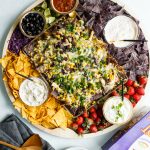 nacho board with chips and toppings