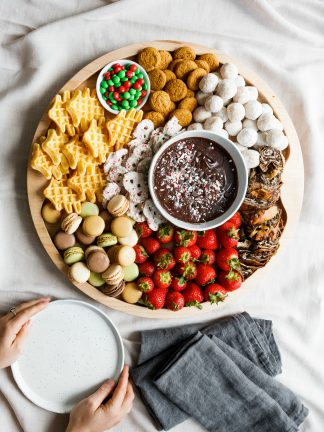 holding plates to serve with a round christmas dessert board