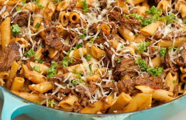 blue braiser of Sugo di Carne with penne pasta