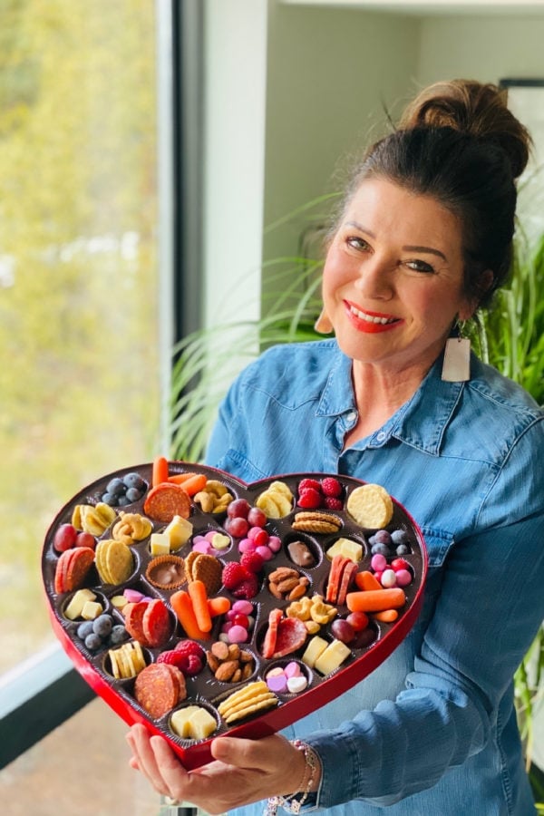 a woman holding a Heart Box Snack