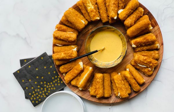 Air Fryer Mozzarella Sticks with Chick-Fil-A Sauce on a wood plate