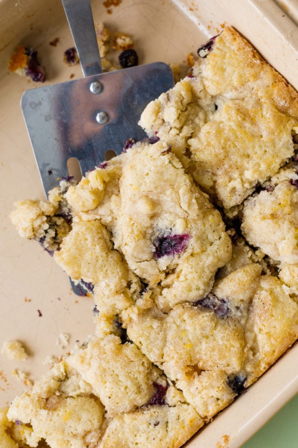 cutting squares of Best Blueberry Kuchen Recipe