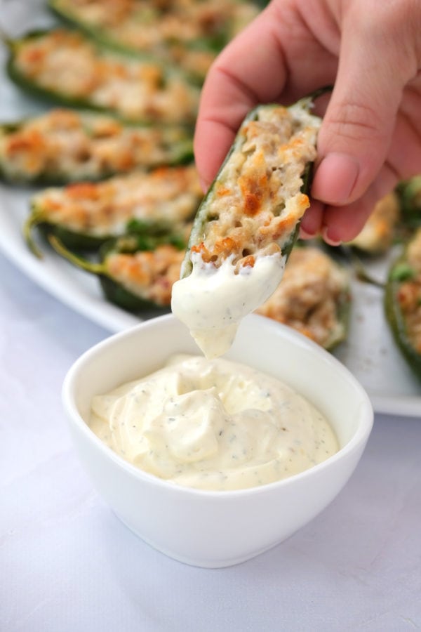 dipping Cheesy Baked Jalapeño Poppers in Ranch dressing