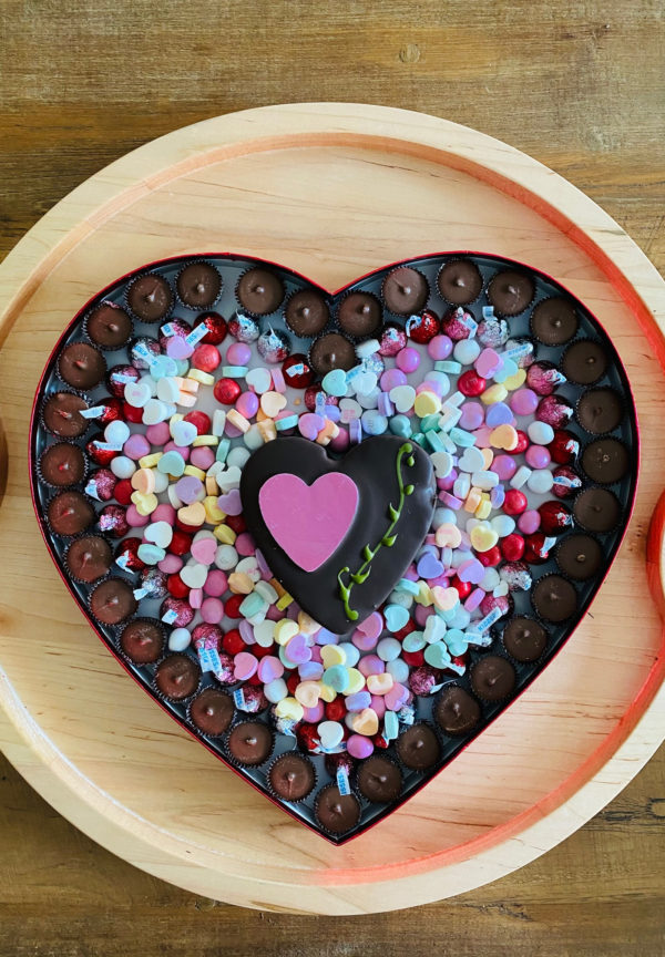 a heart shaped chocolate box on a board