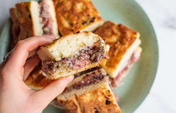 taking a bite of Charcuterie Sliders