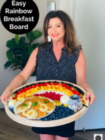 woman holding a rainbow breakfast board