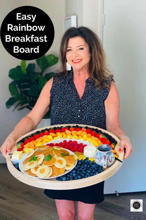 woman holding a rainbow breakfast board