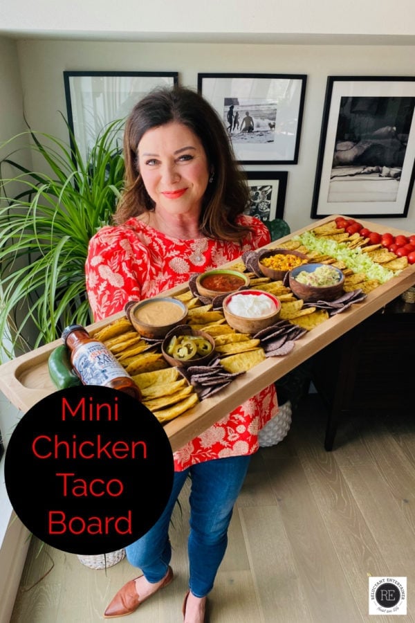 woman holding mini chicken tacos