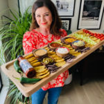 woman holding a chicken taco board