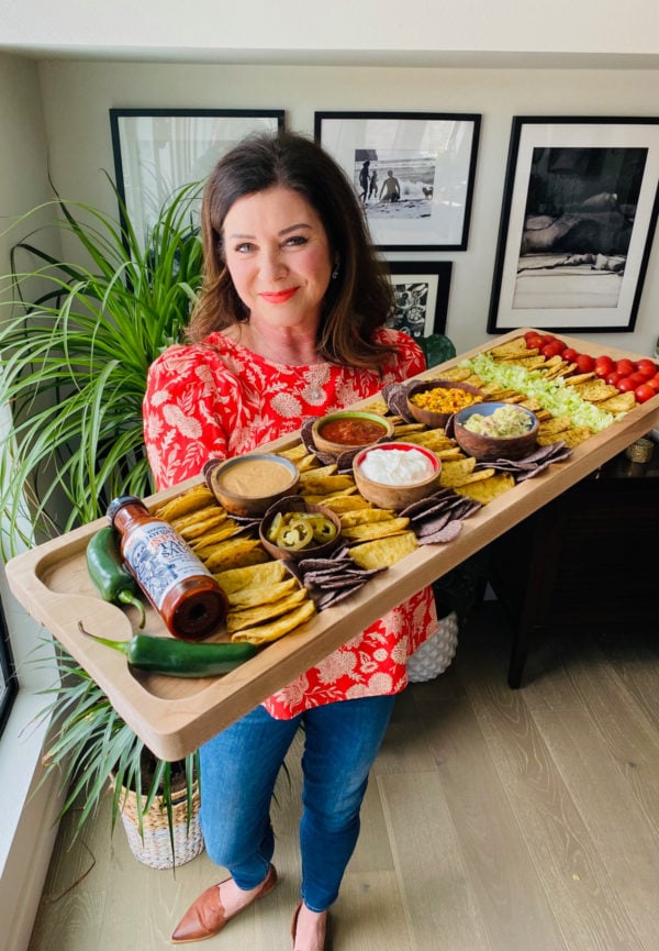 woman holding a chicken taco board