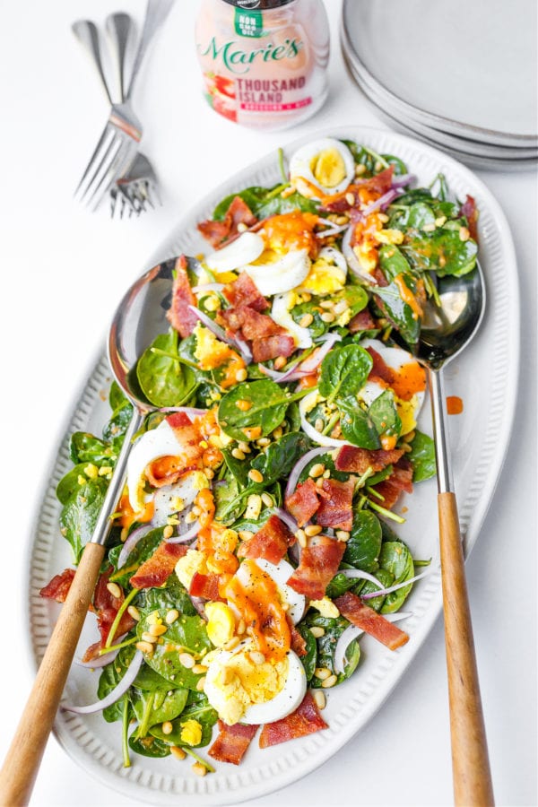 oval platter of Spinach Salad with Warm Bacon Dressing