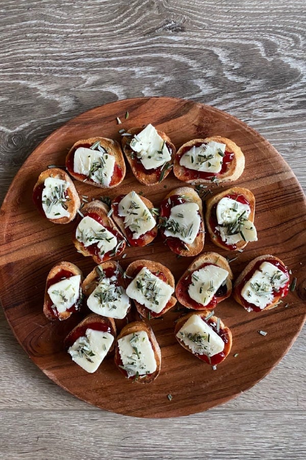 Strawberry Brie Crostini Appetizer on a wood plate