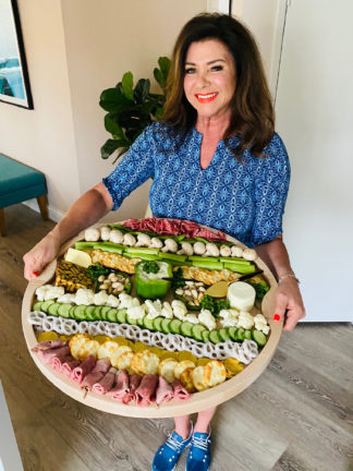 woman holding a St. Patrick's Day Grazing Board