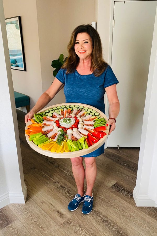 holding a round veggie board