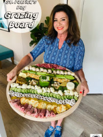 woman holding a round St. Patrick's Day Grazing Board