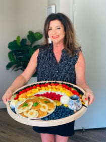 woman holding an Easy Rainbow Breakfast Board