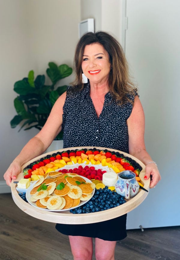 woman holding an Easy Rainbow Breakfast Board