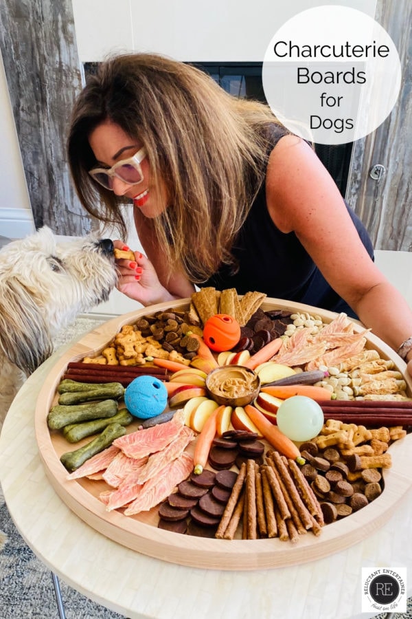 a round dog charcuterie board with a whoodle dog