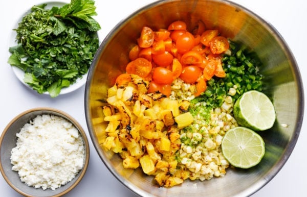 ingredients in a bowl for Grilled Corn Pineapple Salad