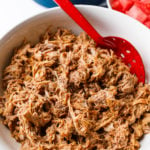serving Slow Cooker BBQ Pulled Pork with red spoon