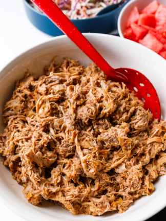 serving Slow Cooker BBQ Pulled Pork with red spoon