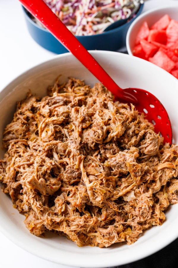 serving Slow Cooker BBQ Pulled Pork with red spoon