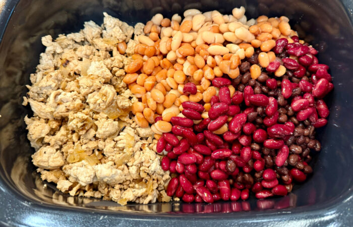 adding mixed beans to meat mixture