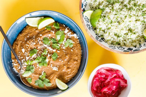 Homemade Refried Pinto Beans with rice and pickled red onions