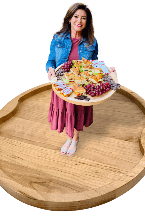 woman holding a food board standing on a board