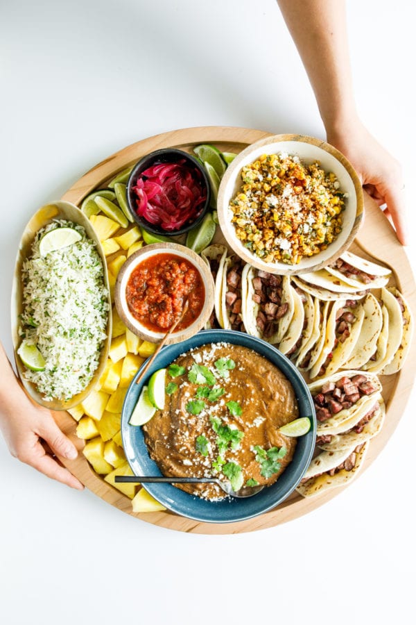 holding a steak taco board