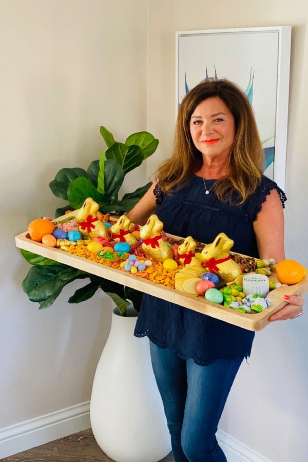 woman holding a 12 x 36 inch Easter Egg Charcuterie Board