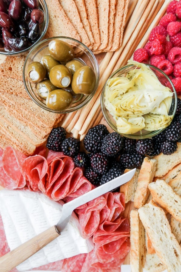 bread stick, olives, meat, cheese, fruit