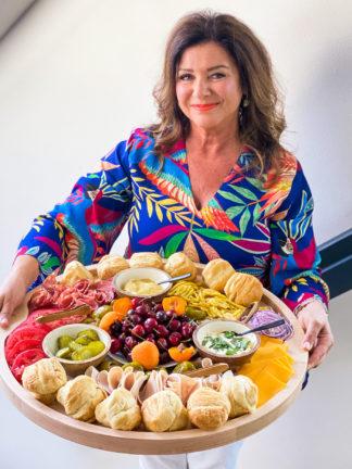 woman holding a round Summer Lunch Turkey Sandwich Board