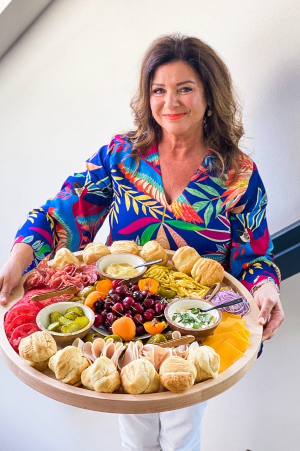 woman holding a round Summer Lunch Turkey Sandwich Board