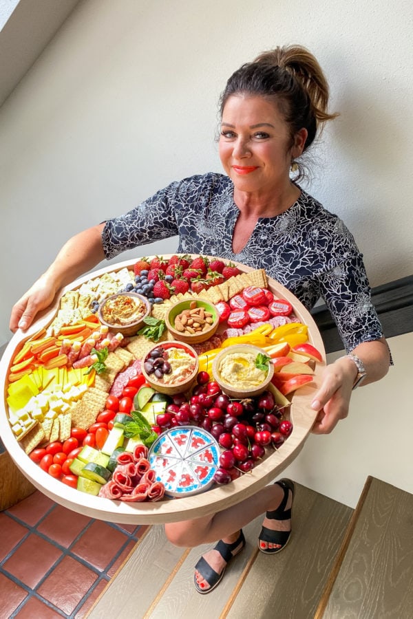 woman holding the Ultimate Classic Hummus Board