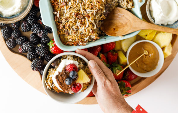 holding a breakfast bowl with baked oats