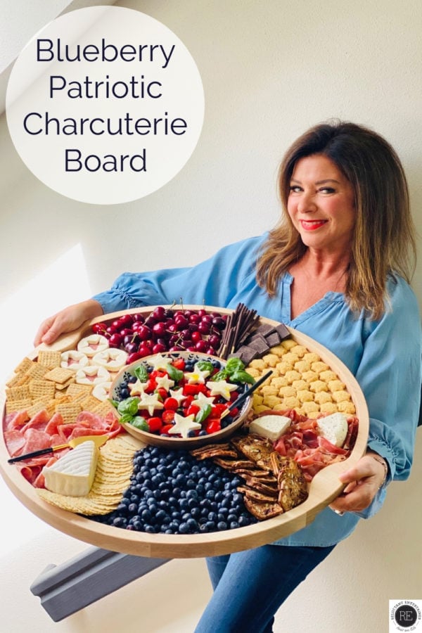 woman holding a big board with patriotic charcuterie foods