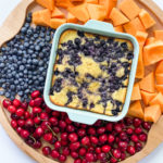 blueberry cake in the center of a fruit board