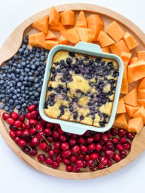 blueberry cake in the center of a fruit board