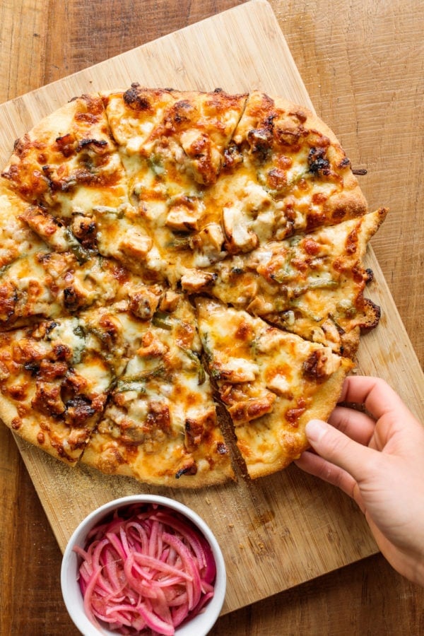 taking a piece of Homemade BBQ Chicken Pizza