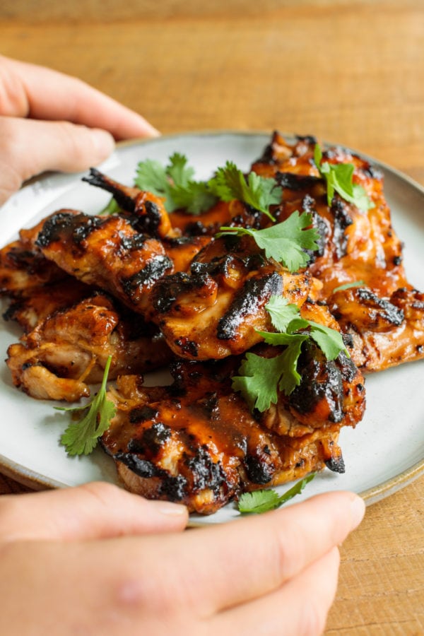 holding plate of Grilled BBQ Marinated Chicken