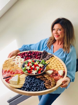 woman holding a Blueberry Patriotic Charcuterie Board