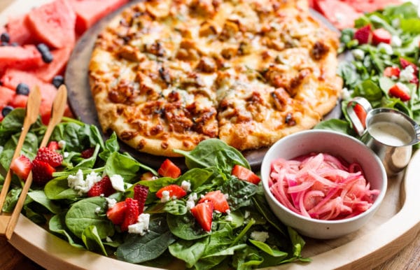 pizza board with pickled red onions