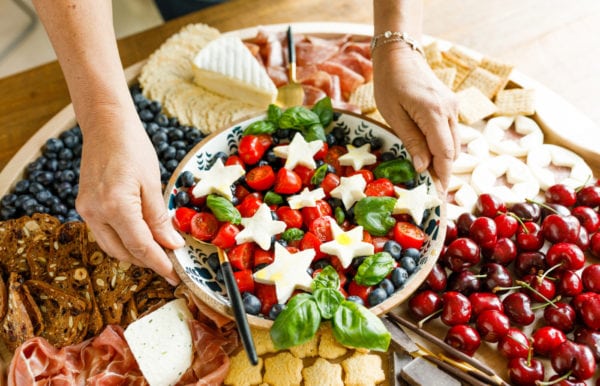 setting down a caprese salad