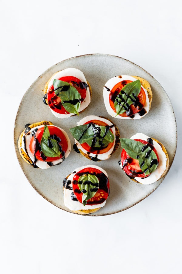 round plate of Grilled Polenta Caprese Appetizers