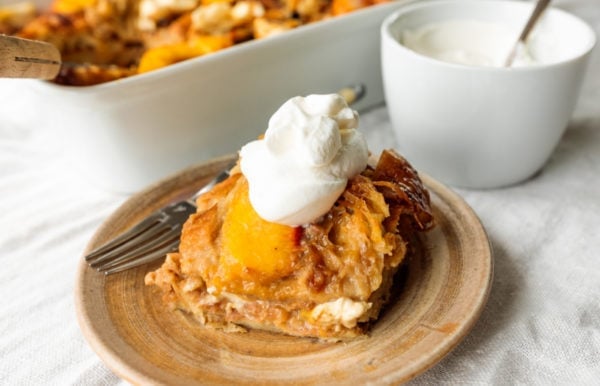 Serving of Peaches and Cream Bread Pudding with whipped cream